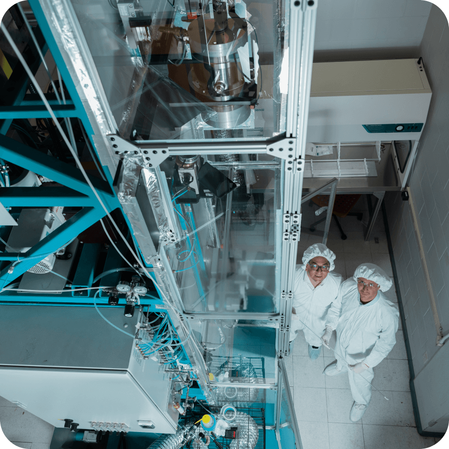 Two man standing new in the factory looking up